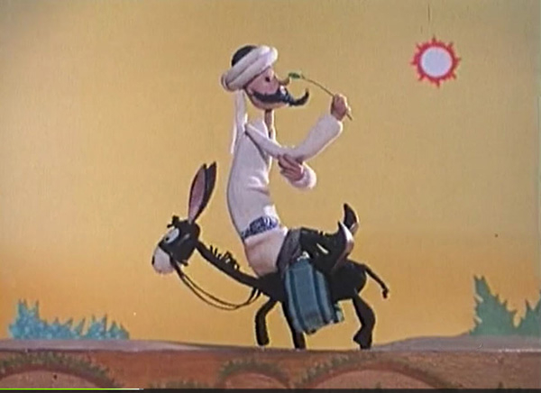 A stop-motion puppet of 阿凡提 riding a mule across a desert landscape